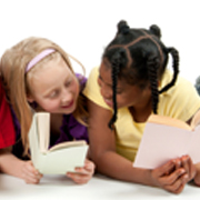 2 young girls reading books together